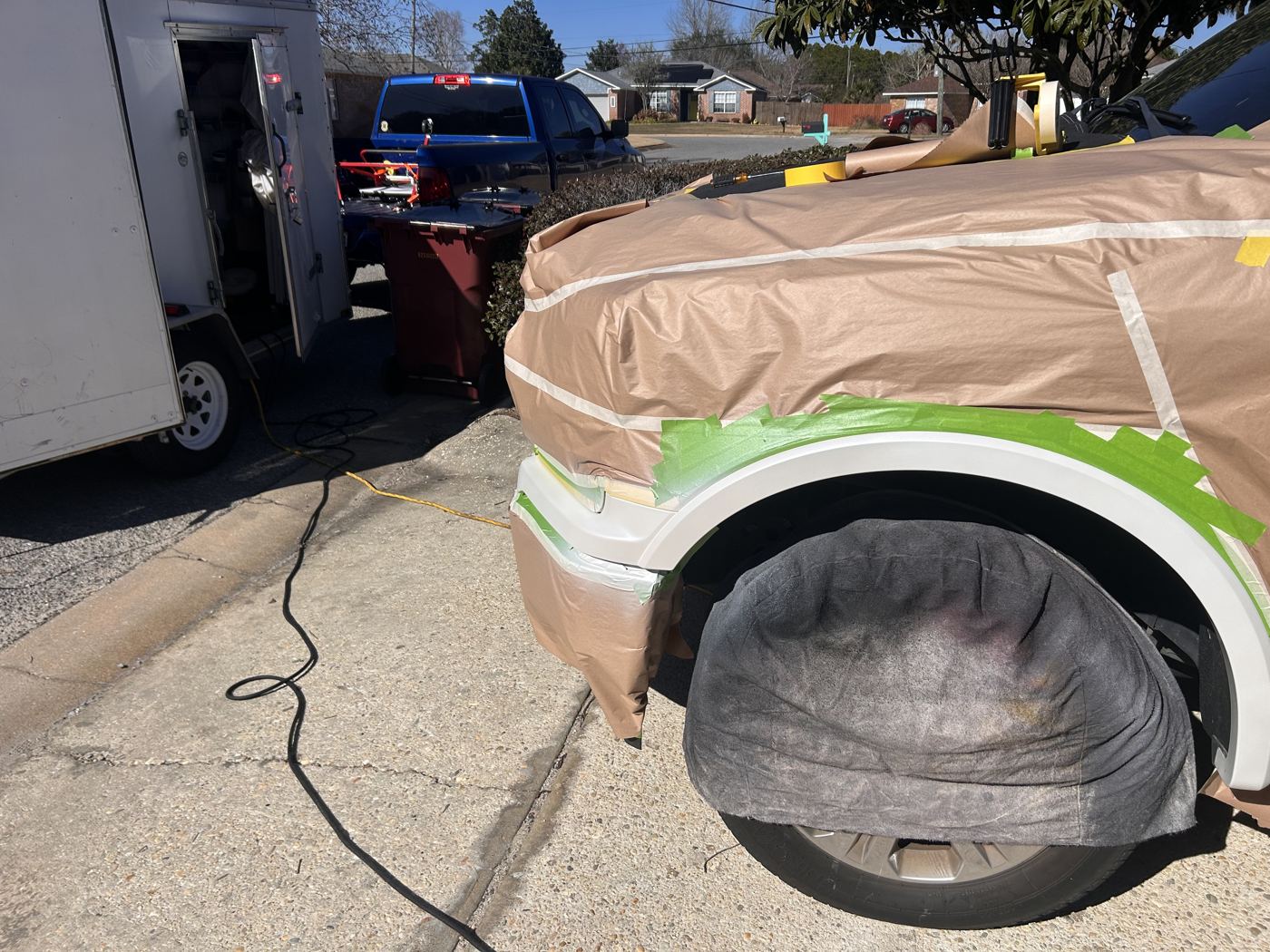 Ford F-150 fender masked in a driveway