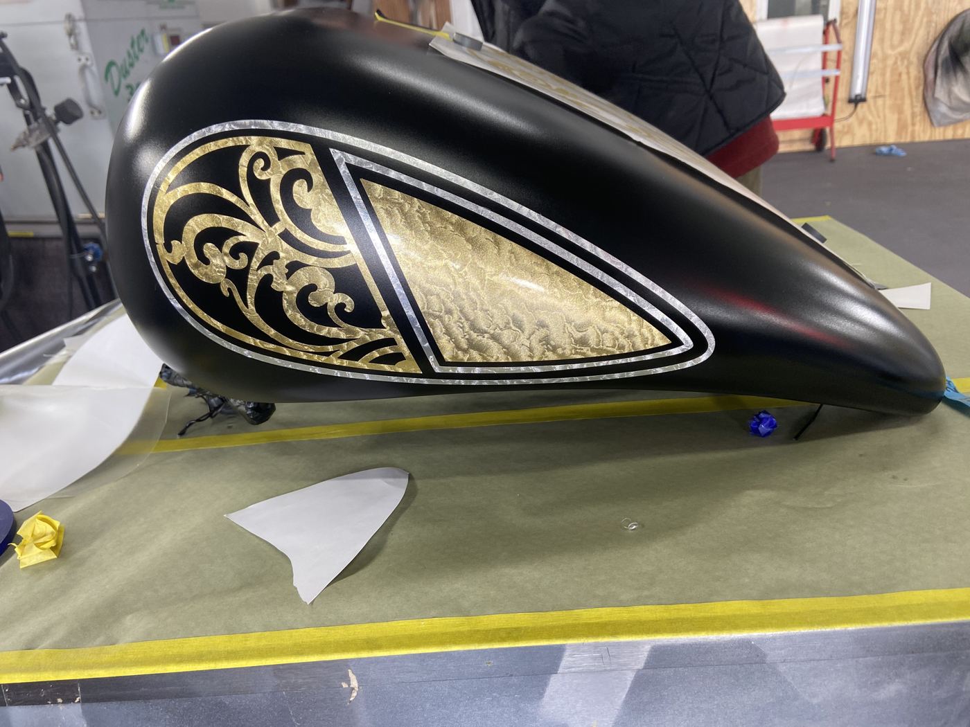 Black motorcycle tank with gold leaf scrollwork