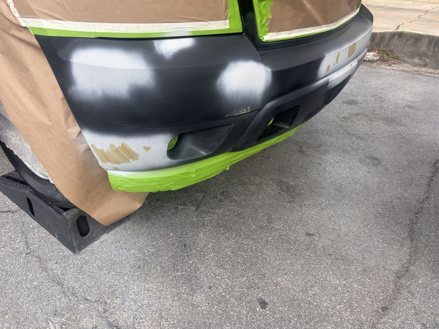 Tahoe bumper masked and primed in a parking lot
